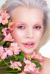 Beauty portrait of blonde model with flowers