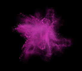 Freeze motion of pink powder exploding, isolated on black