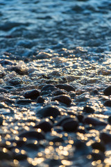 Stones on beach and sea water