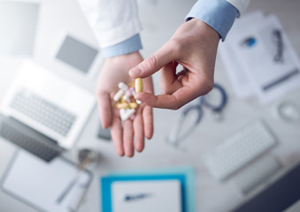 Doctor giving a lot of pills