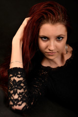 Woman with beauty long red hair - posing at studio