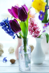 Beautiful bouquets of spring flowers on windowsill background