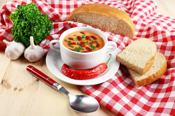 Bean soup in bowl with fresh sliced bread