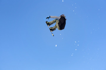 Snowboarder jumps in Snow Park