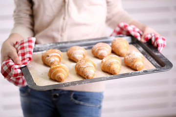 Obraz na płótnie Canvas Croissant on pan in hands
