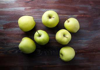 Green apples on wooden background