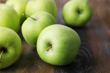 Green apples on wooden background