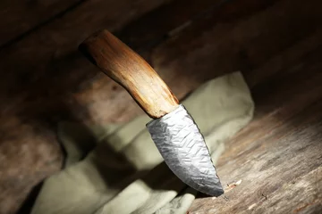 Gordijnen Hunting knife and sackcloth on wooden background © Africa Studio