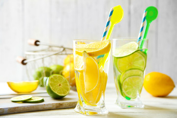 Cocktails with fresh citrus fruits on wooden background