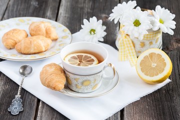 Tea with lemon and croissants