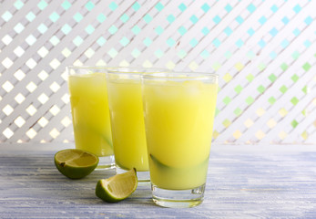 Glasses of cocktails on wooden lattice background