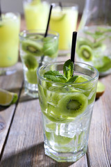 Glasses of cocktails on wooden table, closeup
