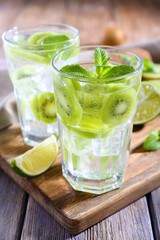 Glasses of cocktails on wooden table, closeup