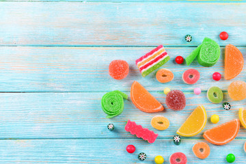 Colorful candies on wooden background