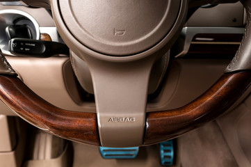 Airbag sign on steering wheel of car. Interior detail.