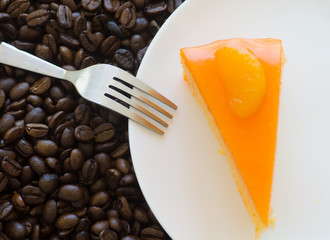 Orange cake  and roasted coffee beans background