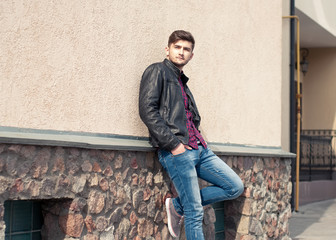 Obraz premium Fashionable handsome man model posing outdoors. Street fashion