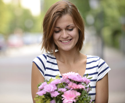 Happy woman holding floral arrangement