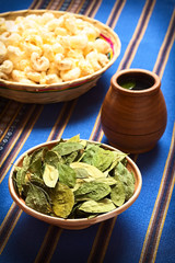 Dried coca leaves in clay bowl