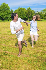 Fototapeta premium Smiling Caucasian Couple Relaxing Outdoors and Having Fun Togeth