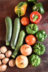 Fresh vegetables and ingredients for pizza on wooden background