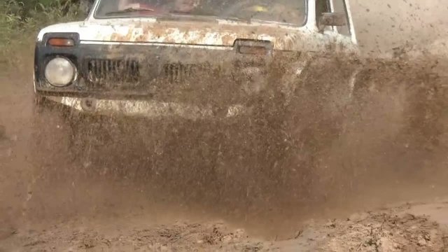 Car SUV Slowed Rides A Rally With Mud Puddle