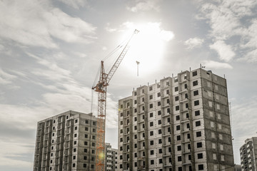 Fototapeta na wymiar New high block construction with a crane