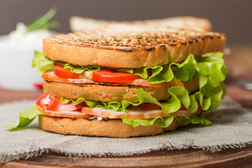 Classic club sandwich with bacon and vegetables