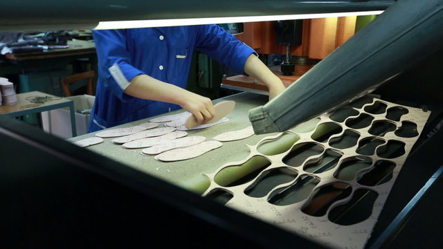 View of worker takes manufactured insoles