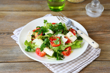Fresh salad with tomatoes, peppers and cheese on a plate