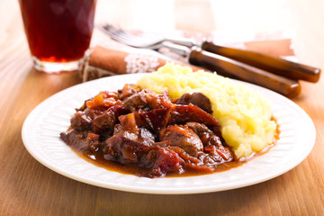Stewed liver with plums and gravy