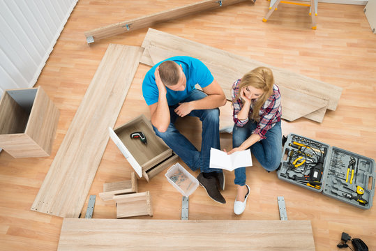 Thoughtful Couple With Disassembled Furniture