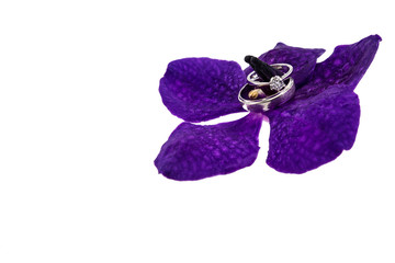 Wedding ring with Purple orchid flower, isolated on white