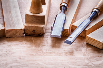 chisels and plane planks on wooden board