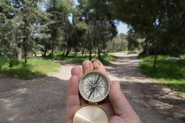 Compass being held out to determine direction