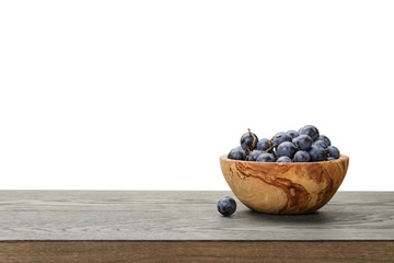 isabella grapes in wood bowl on table, border compostition