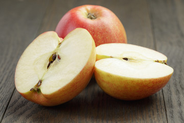 seasonal red apples sliced on wooden table