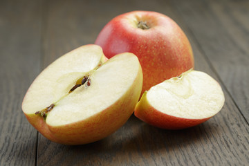 seasonal red apples sliced on wooden table