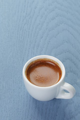 cup of fresh espresso on vintage blue table