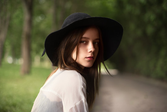 portrait of a beautiful young girl in a hat