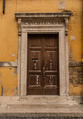 Fototapeta na wymiar An old Roman doorway, set in an ochre coloured wall