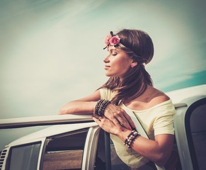 Hippie girl in a van on a road trip