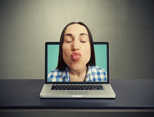 kissing woman got out of the laptop