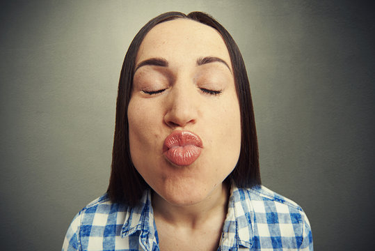 Wide Angle Portrait Of Kissing Woman