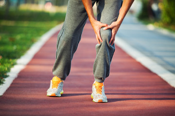 Man having pain in leg while jogging