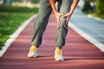Papier Peint photo autocollant Jogging Man having pain in leg while jogging