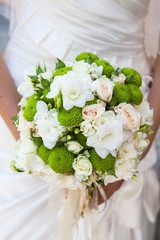 Beautiful wedding bouquet in hands of the bride