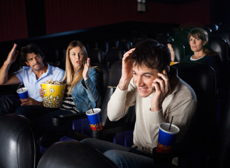 Spectators Shouting Man Using Mobilephone In Theater © Tyler Olson