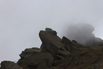 rocks on mountain in cloud