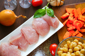 Sliced turkey meat and vegetables on the tables